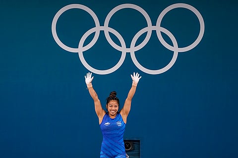 Mirabai Chanu celebrates after her successful third attempt during the snatch stage of the women's 49kg weightlifting